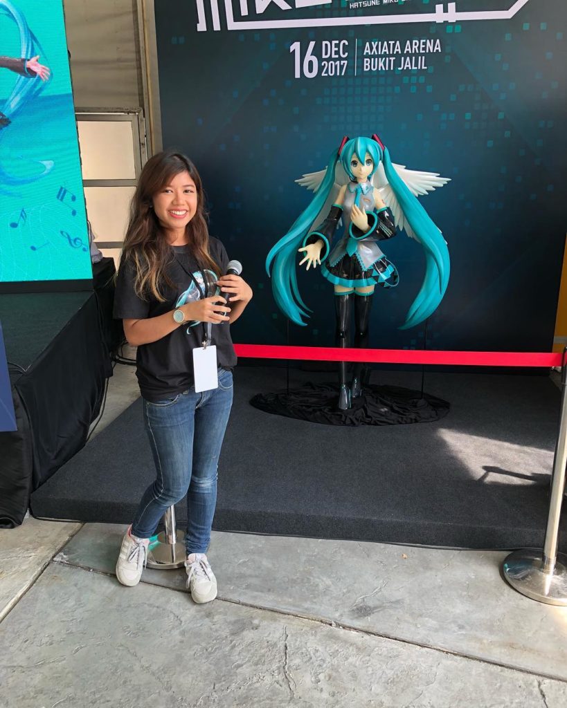 Natasha posing beside a figure of virtual vocalist Hatsune Miku. Photo: Natasha Hidayah Hashim