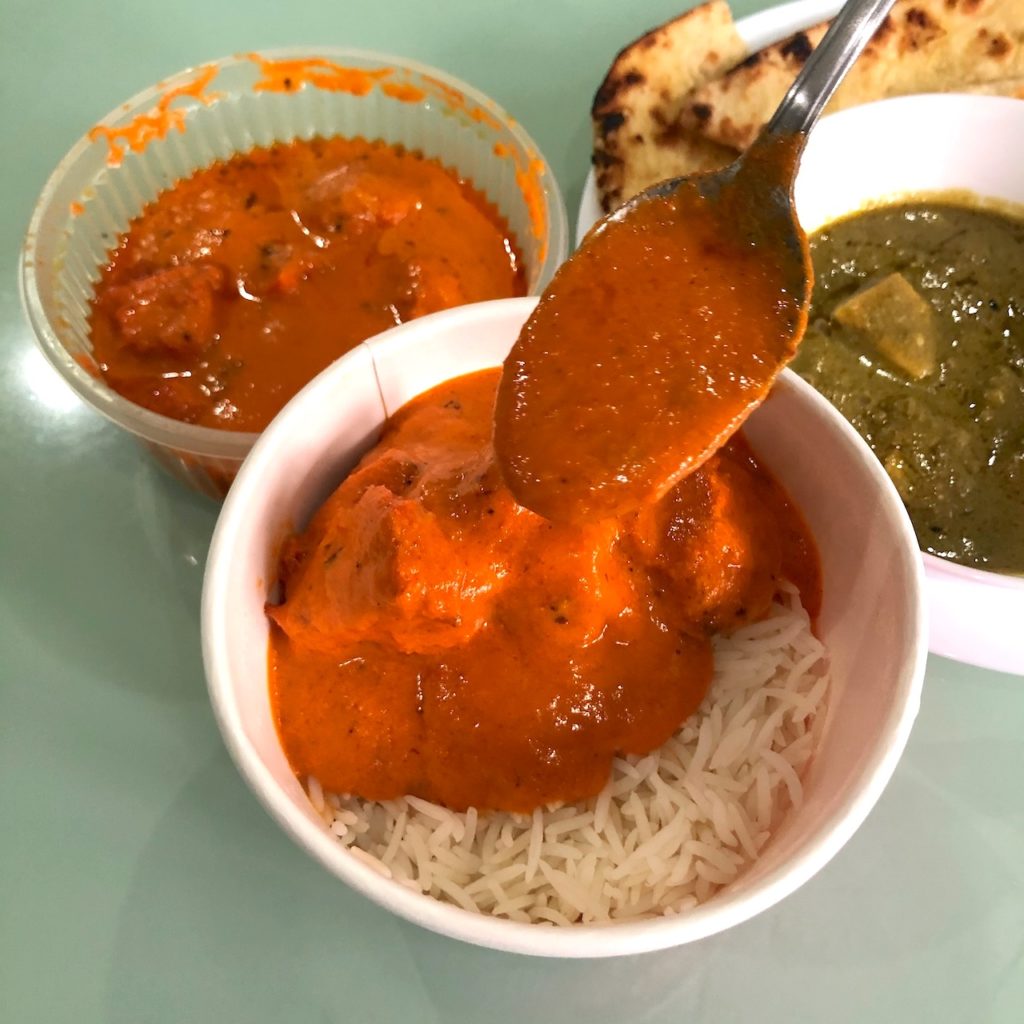 Butter Chicken slathered on top of basmati rice. Photo by Nadia Vetta Hamid for Coconuts Media