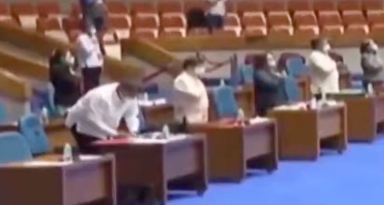 Remulla taking notes while the national anthem plays at the start of the House Committee hearing on ABS-CBN franchise. <i>Video grab via YouTube</i>