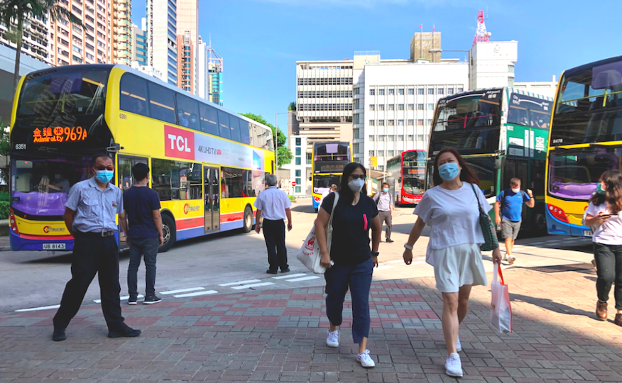 Commuters walk through the Central (Macau Ferry) Bus Terminus in Sheung Wan on July 23, 2020. Photo via Coconuts Media