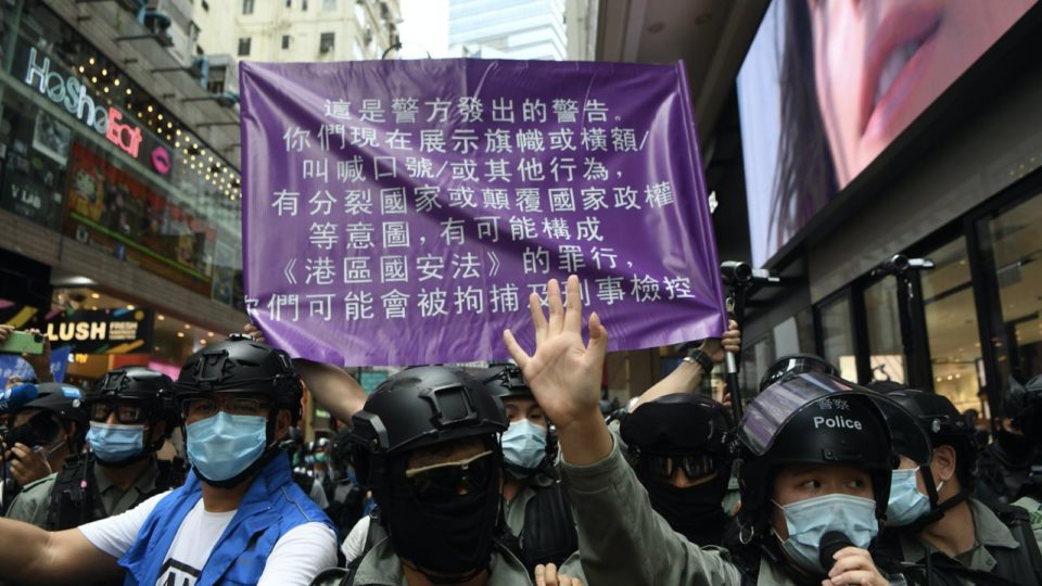 Hong Kong police hold up a purple flag, which warns the public that their actions may breach the national security law, on July 1, 2020. Photo via Facebook/Hong Kong Police