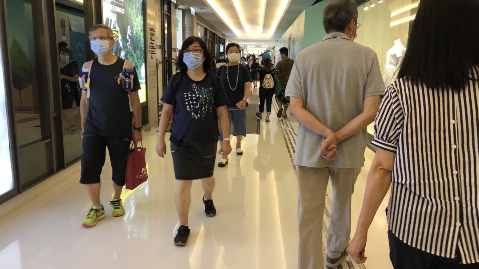 People walk through a corridor in New Town Plaza in Sha Tin on July 30, 2020.