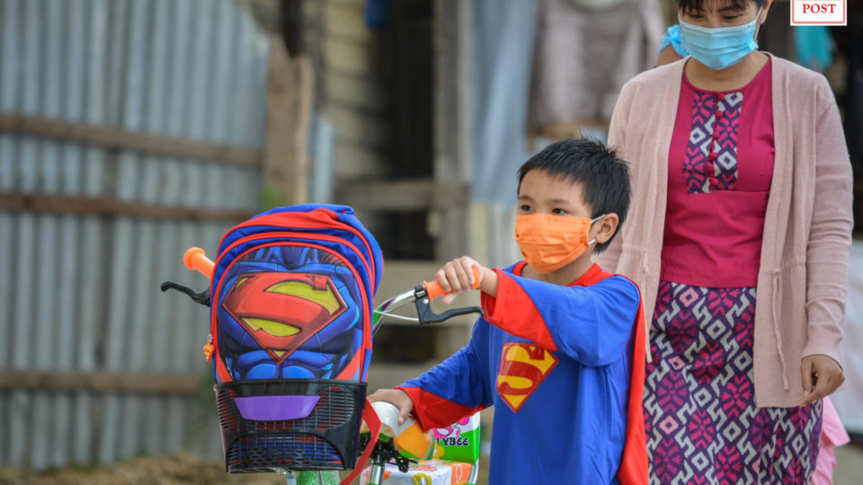 Nurses and doctors applaud him as he walks out of the hospital, some help him with the bicycle he just received and a superman kid backpack. By “him,” we mean a 6-year-old boy with a Superman costume given as a gift by Tedim General Hospital in Chin State.