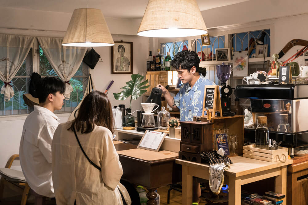 Poony makes filter coffee for his customers