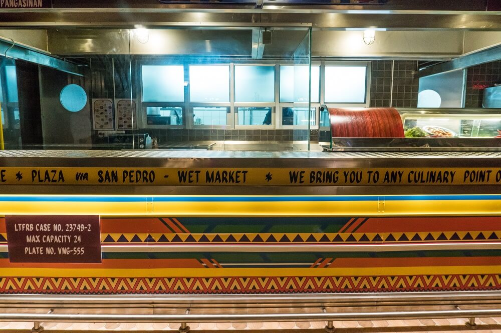 The counter is decorated in the dizzying colors of a Jeepney, a popular form of public transportation in the Philippines. 