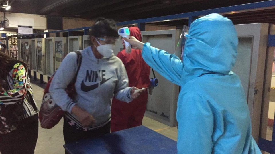 An MRT passenger gets his temperature taken before boarding. Photo: Department of Transport/FB