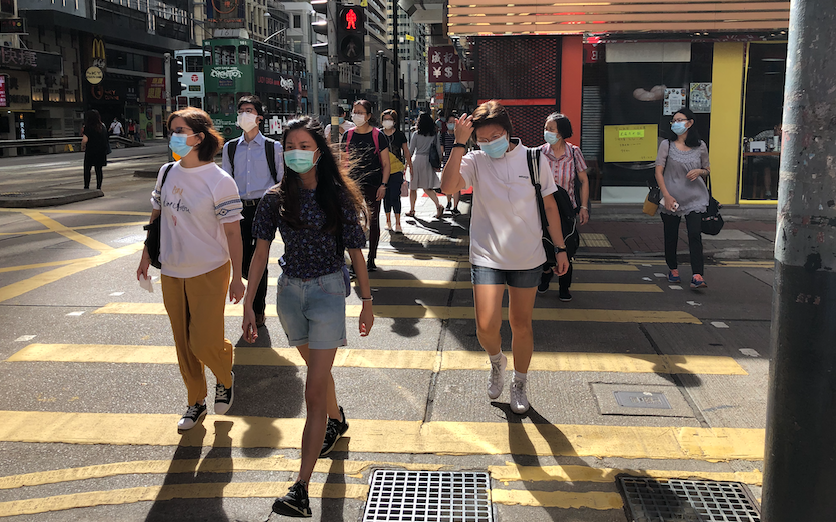 Pedestrians cross a street in Sheung Wan on Aug. 5, 2020. Photo: Coconuts Media