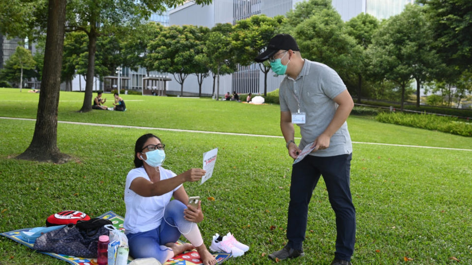 Food and Environmental Hygiene Department (FEHD) authorities patrol gatherings of domestic workers in Tamar Park, Admiralty, on Aug. 9, 2020.