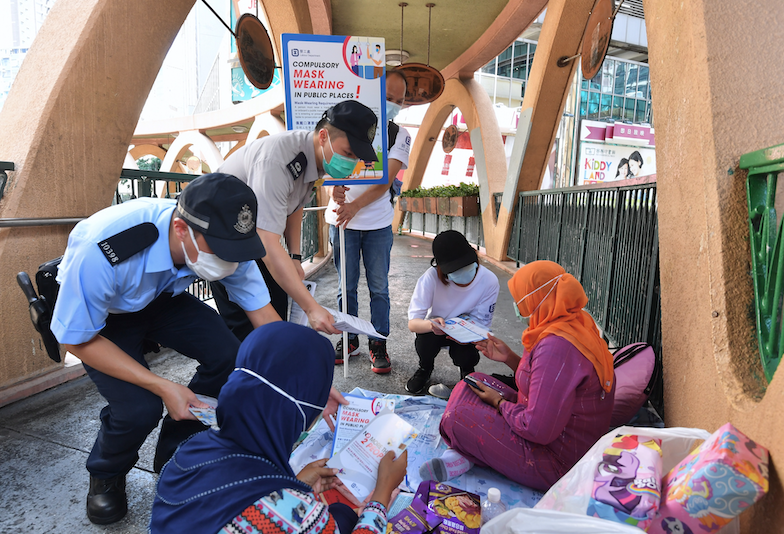 Police patrol gatherings of domestic workers in Causeway Bay, Hong Kong.