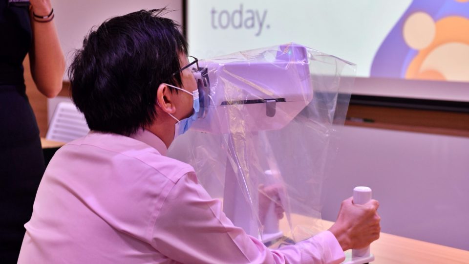 A man trying out the SwabBot. Photo: National Cancer Centre Singapore/Facebook
