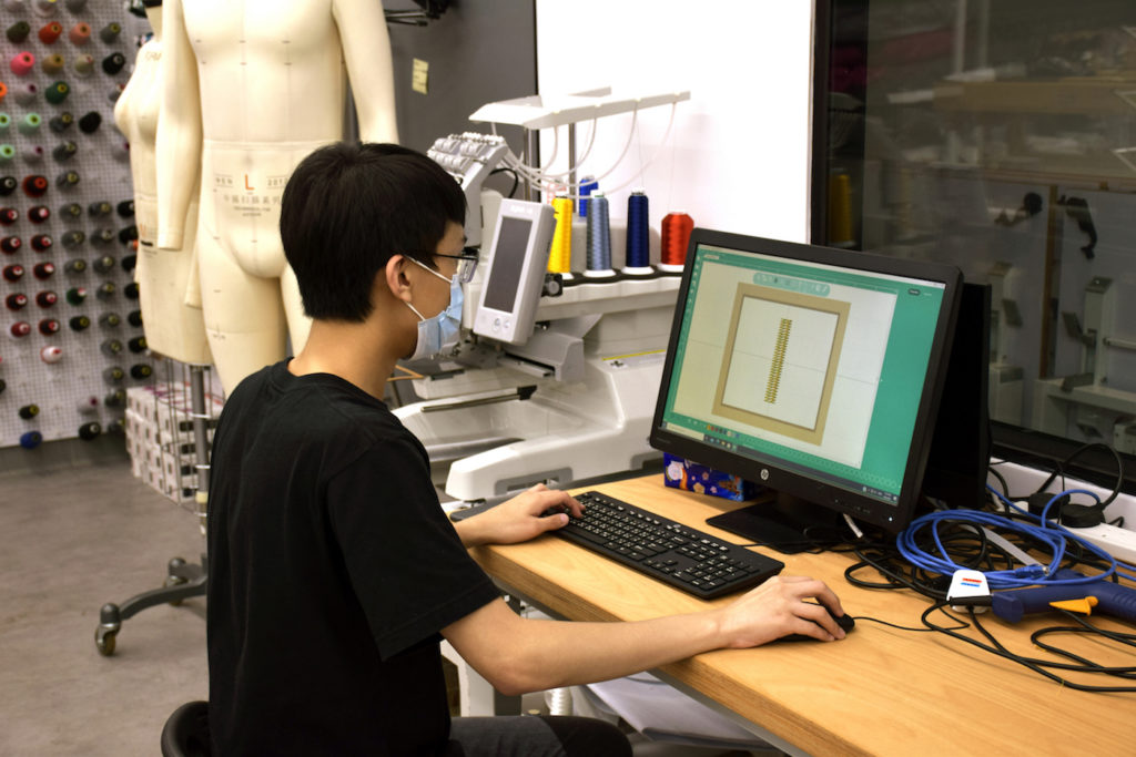 Gabriel Mataleo works on a weaving simulation project at his internship workplace. Photo: Thomas Shum for Coconuts