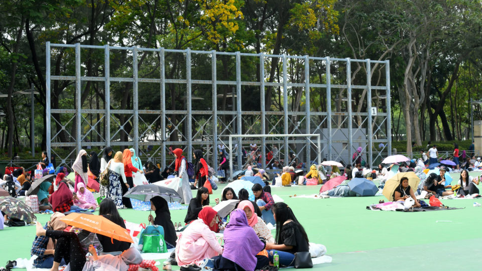 Domestic workers gather on their rest day at Victoria Park in Causeway Bay. Photo via the Hong Kong government’s Information Services Department