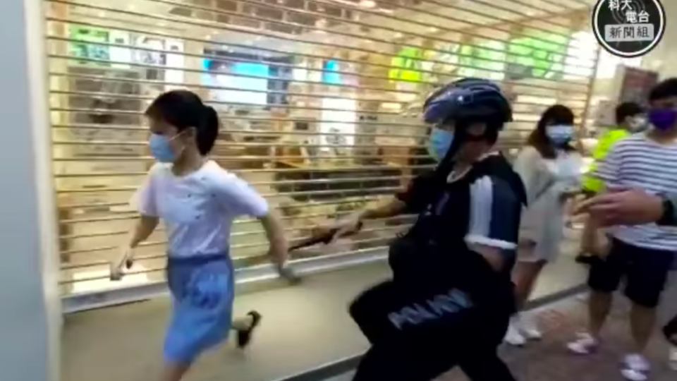 Police tackle a 12-year-old girl during a protest in Mong Kok on Sept. 6, 2020. Screenshot via Facebook/HKUST Radio News Reporting Team