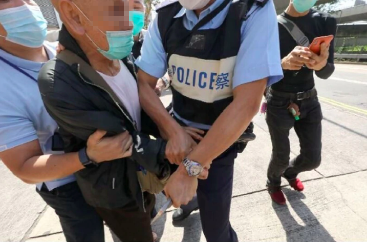 Police subdue the attacker outside the Liaison Office on April 16, 2020. Photo via Apple Daily