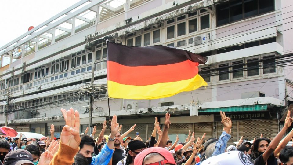 Protesters carry a German flag as they march Oct. 14 from the Democracy Monument to the Government House. Photo: Coconuts
