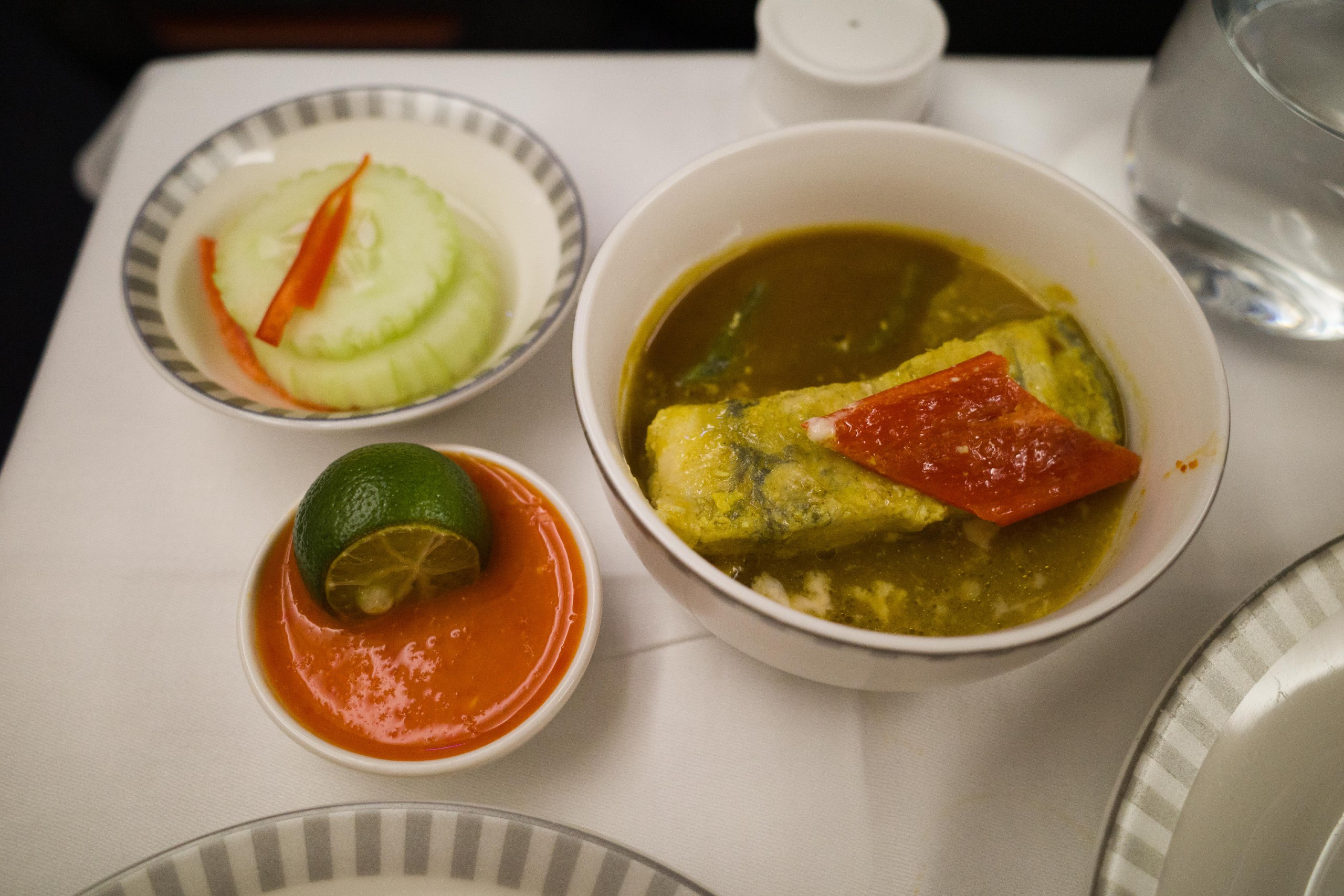 The fish in turmeric gravy with pickled cucumbers and chilli on the side. Photo: Coconuts