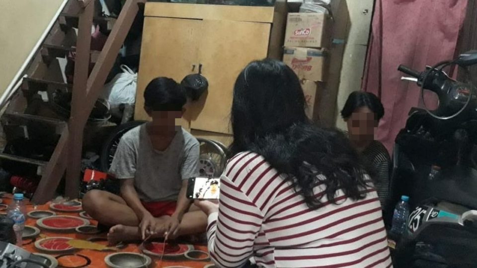 Aditya (in grey shirt) and his older brother Rivai at their home in Palmerah, West Jakarta. Photo: Istimewa