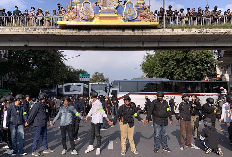 Protesters are stopped at the final barricade between their march and the Government House.