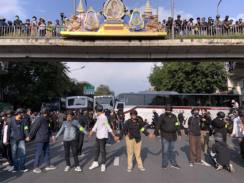 Protesters are stopped at the final barricade between their march and the Government House.