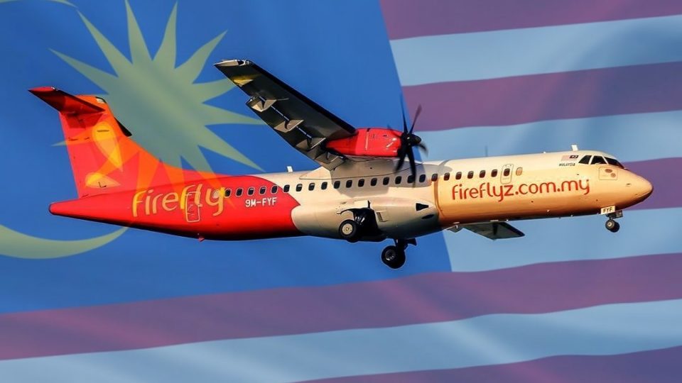 Photo of a Firefly airplane with Malaysia’s flag in the background. Photo: Coconuts