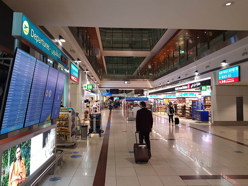 A traveler walks down a desolate transit area Sept. 27 at Dubai International Airport.