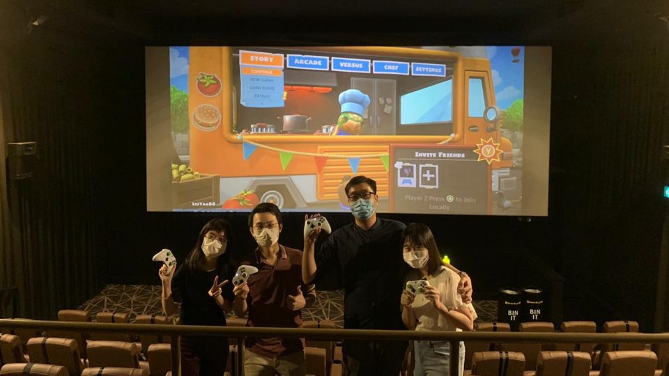 Overcooked: Gaming squad poses with their Xbox controllers in a cinema hall. Photo: Les Yam/Facebook
