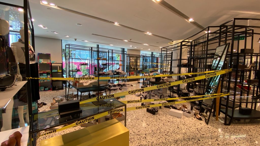 Opened boxes of shoes thrown all around the floor in an area cordoned off by ‘caution’ tapes at The Heeren outlet. Photo: Coconuts