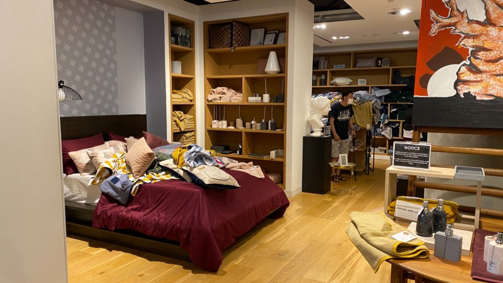 Pillows and bedsheets removed from shelves and left on a bed in the bedding section at The Heeren outlet. Photo: Coconuts