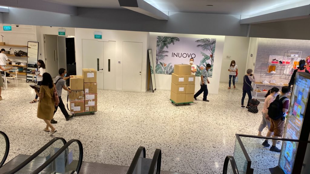 Staff wheeling boxes of goods into the storage area at the back of the store at The Heeren outlet. Photo: Coconuts