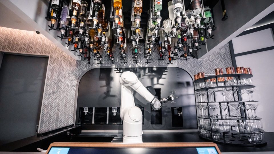 The robot bartender posing with a martini glass at its station. Photos: Ratio 
