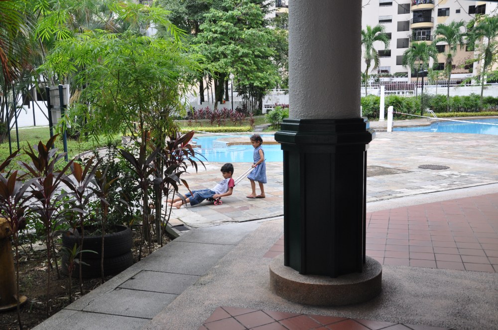 A boy and a girl playing with a makeshift wheelbarrow. Photo: Coconuts