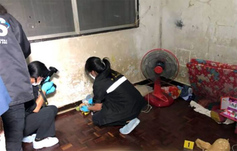 Police investigators at the scene where a 15-year-old Nonthaburi boy was found dead with his head wrapped in duct tape.