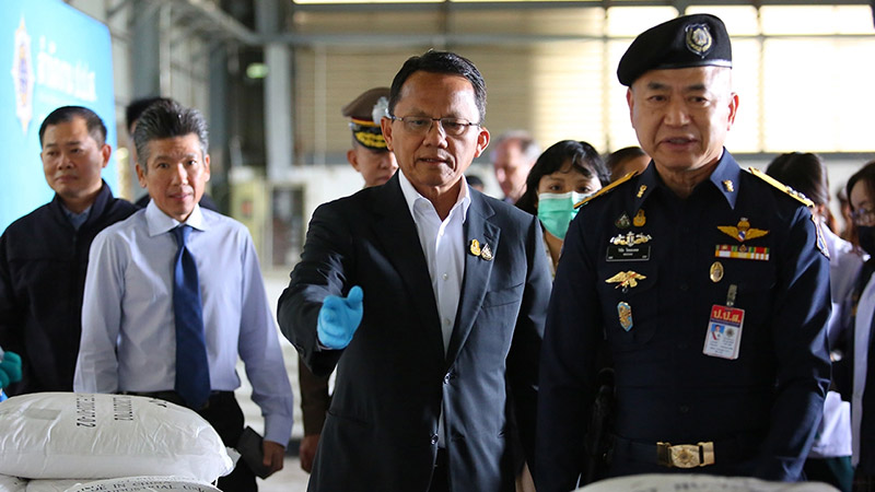 Justice Minister Somsak Thepsuthin and police officers with 475 bags of suspected ketamine on Nov. 12 at a warehouse in Chachoengsao province.