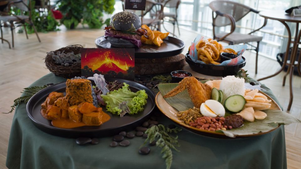 Clockwise from top left: the Jurassic World Burger, the Curly Fries, the Nasi Lemak and the Volcano Curry. Photo: Coconuts
