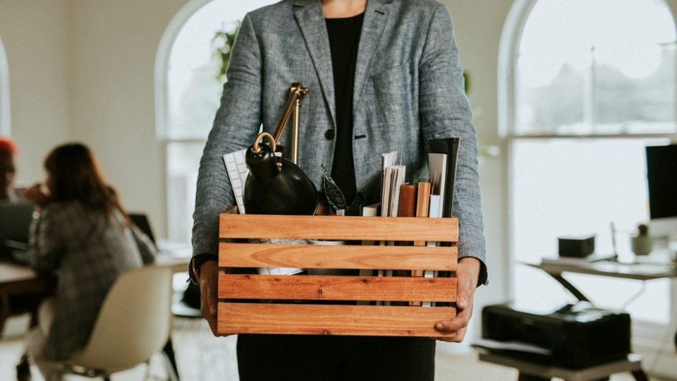 File photo of a person holding a box of personal belongings. Photo: Felix/Rawpixel
