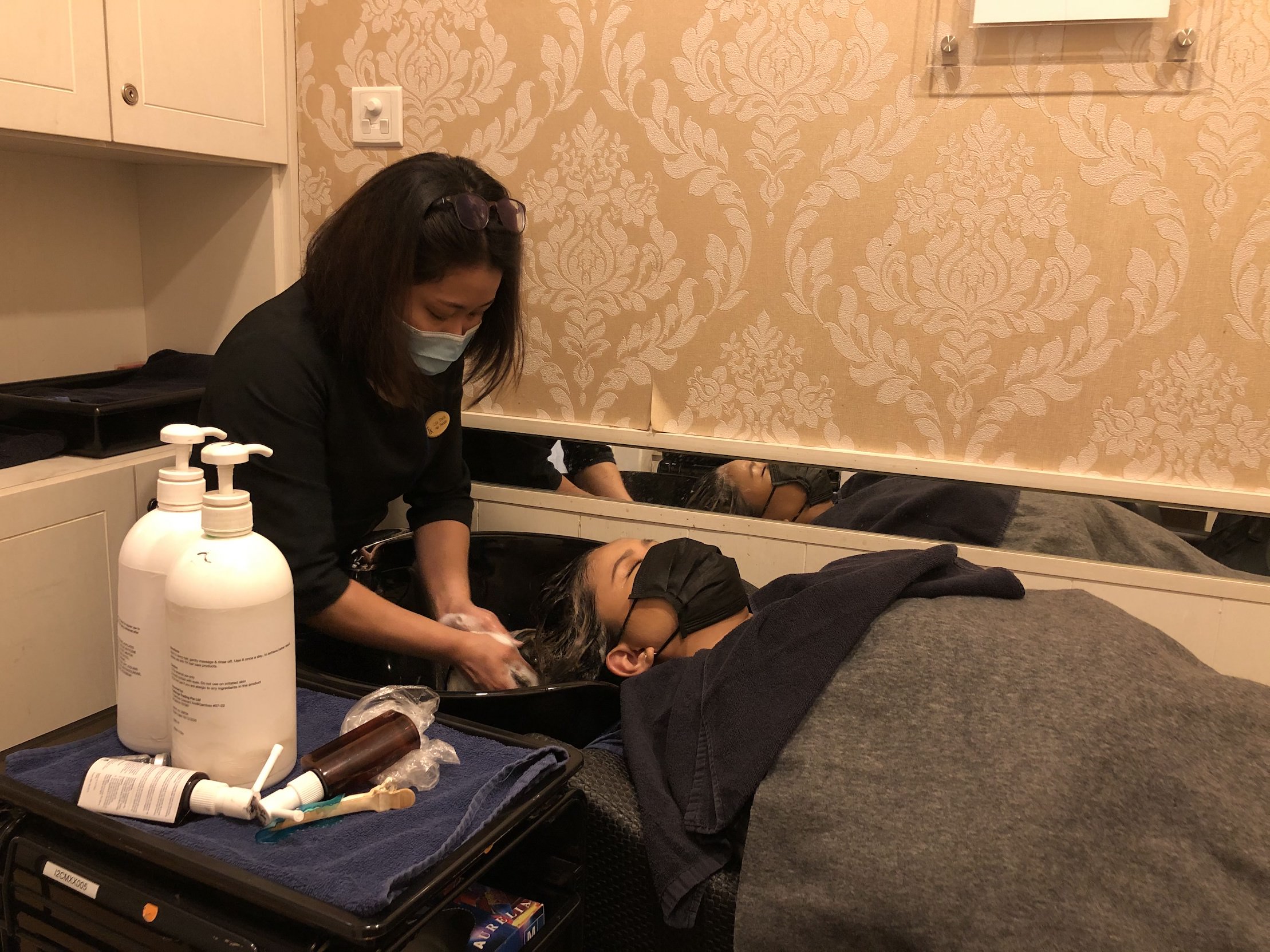 Me living my best life and enjoying the relaxing hair wash by my hair therapist, Lisa. Photo: Coconuts Singapore