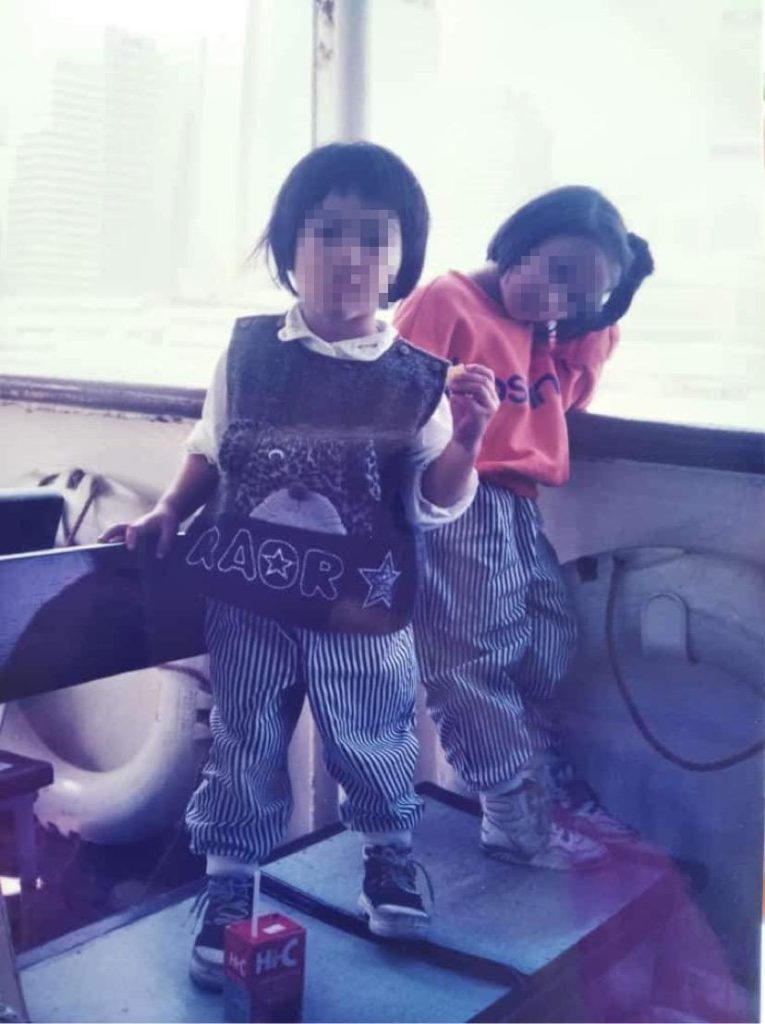 5-year-old Kaye, (left) and 4-year-old Dawn (right) take the Star Ferry in 1994. Faces censored upon request.