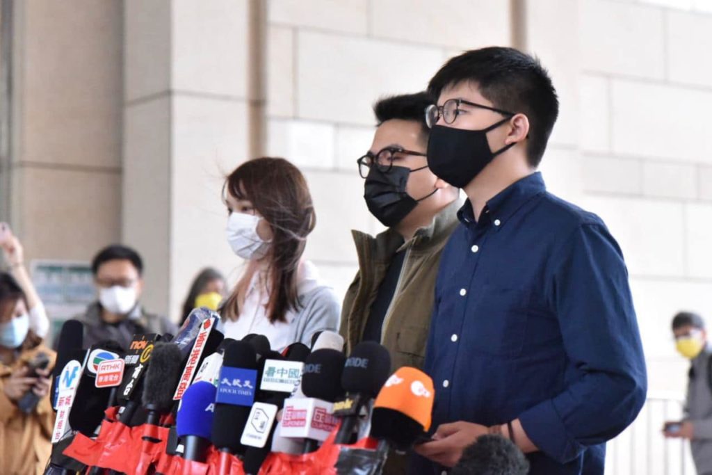 Activists Joshua Wong, Ivan Lam and Agnes Chow speak with reporters outside the West Kowloon Magistrates' Courts on Nov. 22, 2020. Photo via Facebook/Joshua Wong