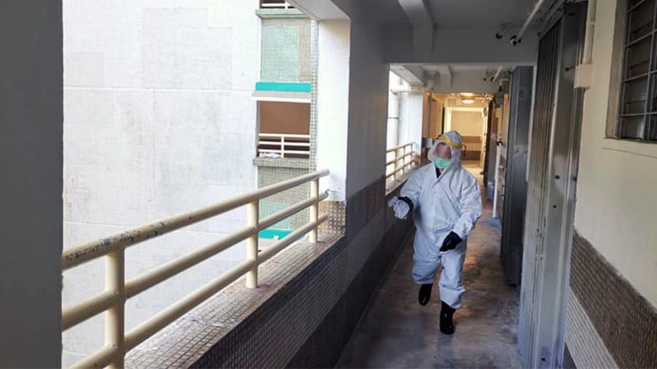 A cleaner in protective gear disinfects Mei Lam Estate in Tai Wai, where the woman lived with her also COVID-positive daughter, on Dec. 18, 2020. Photo: Facebook/Ng Ting Lam
