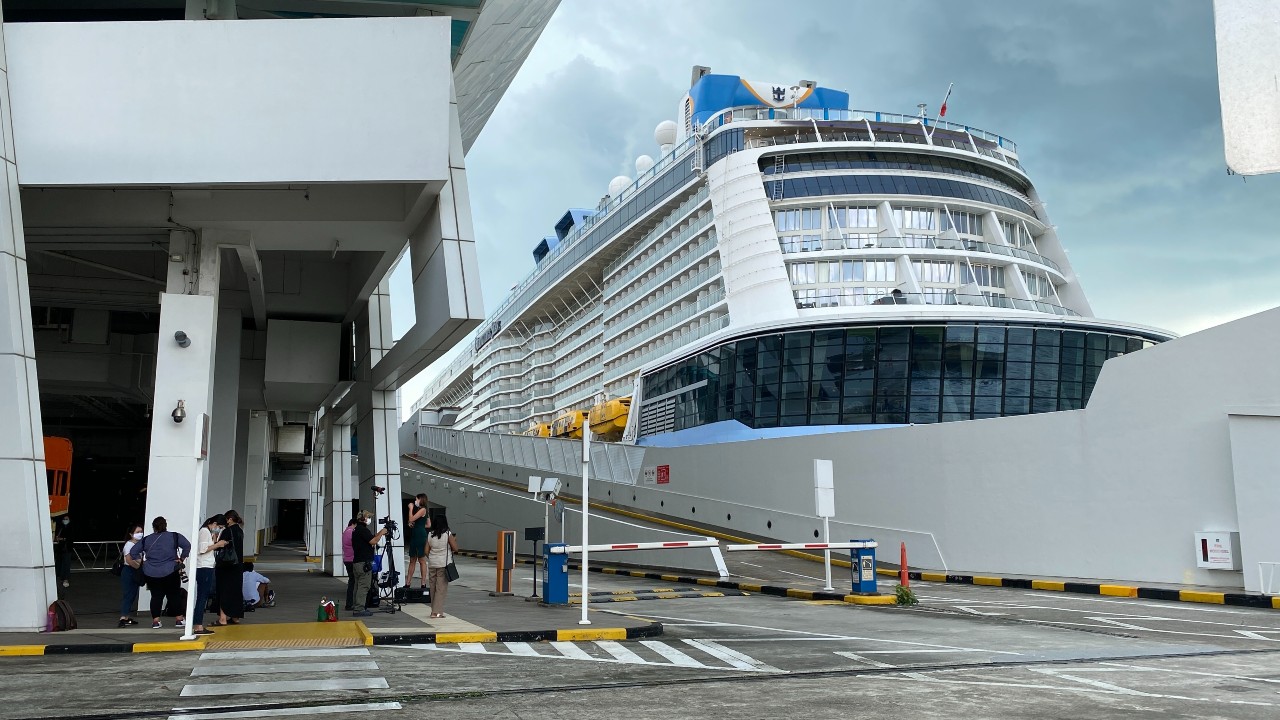 Reporters gather outside the Royal Caribbean’s Quantum of the Seas cruise ship at the Marina Bay Cruise Center on Dec. 9, 2020. Photo: Carolyn Teo/Coconuts