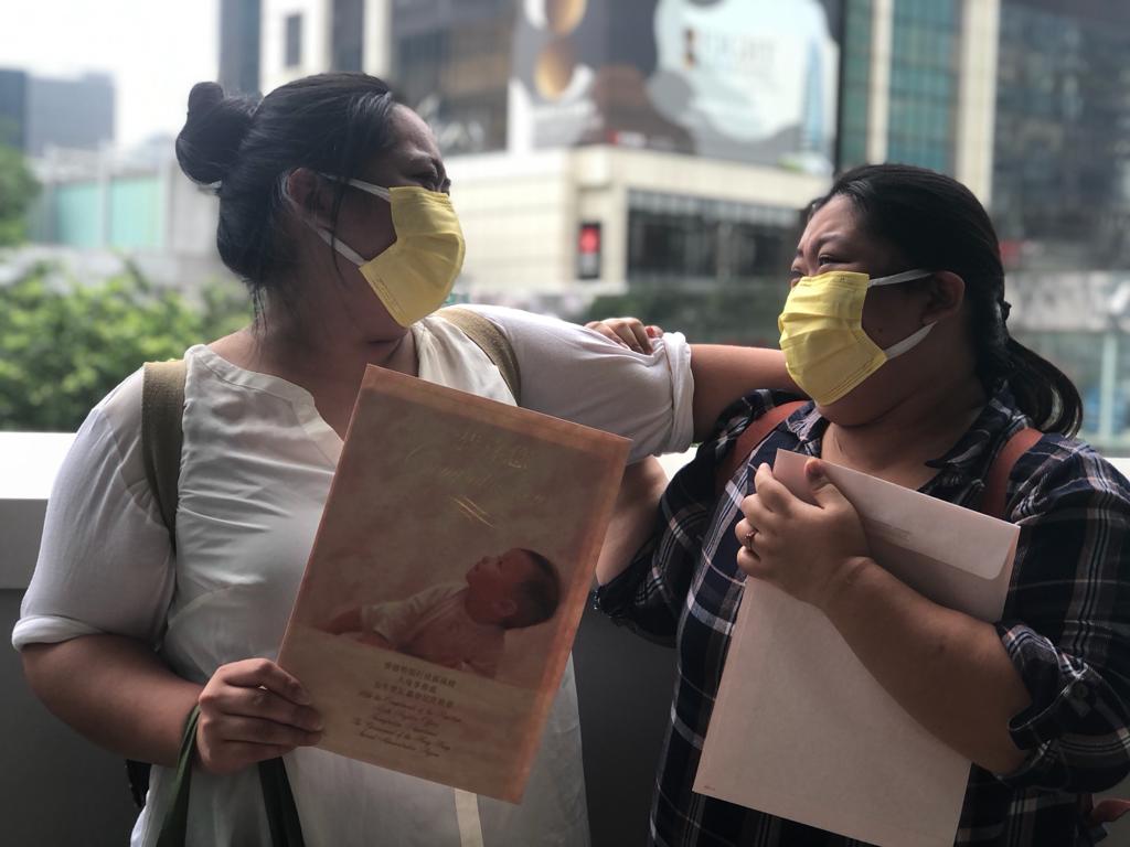 The sisters stopped for a photo outside the Birth Registry in Admiralty after they received the long-awaited documents. Photo: Pathfinders