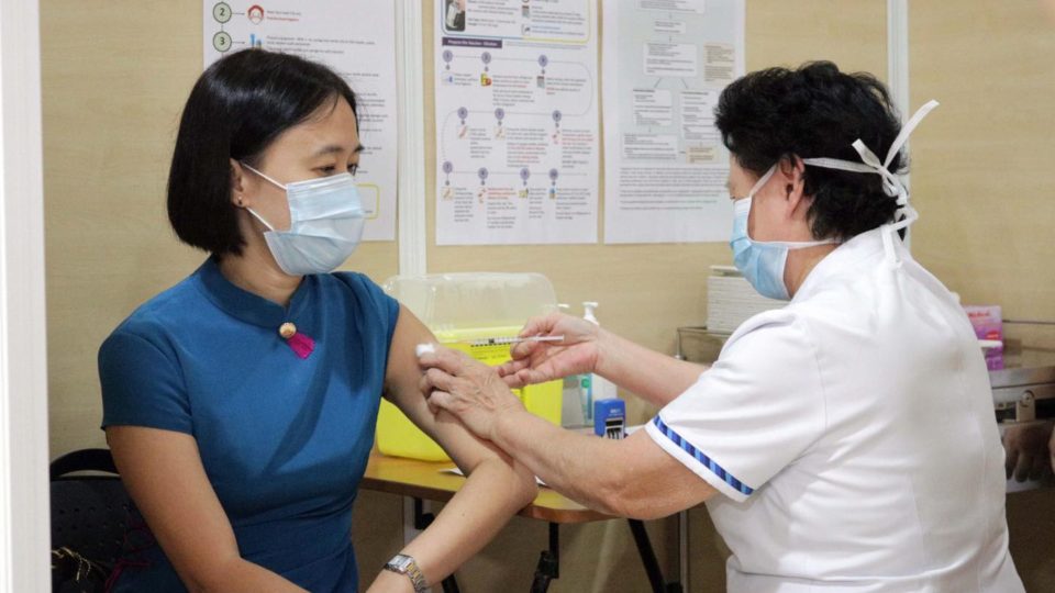 A nurse administers a COVID-19 vaccine to a woman at Singapore General Hospital. Photo: Singapore General Hospital
