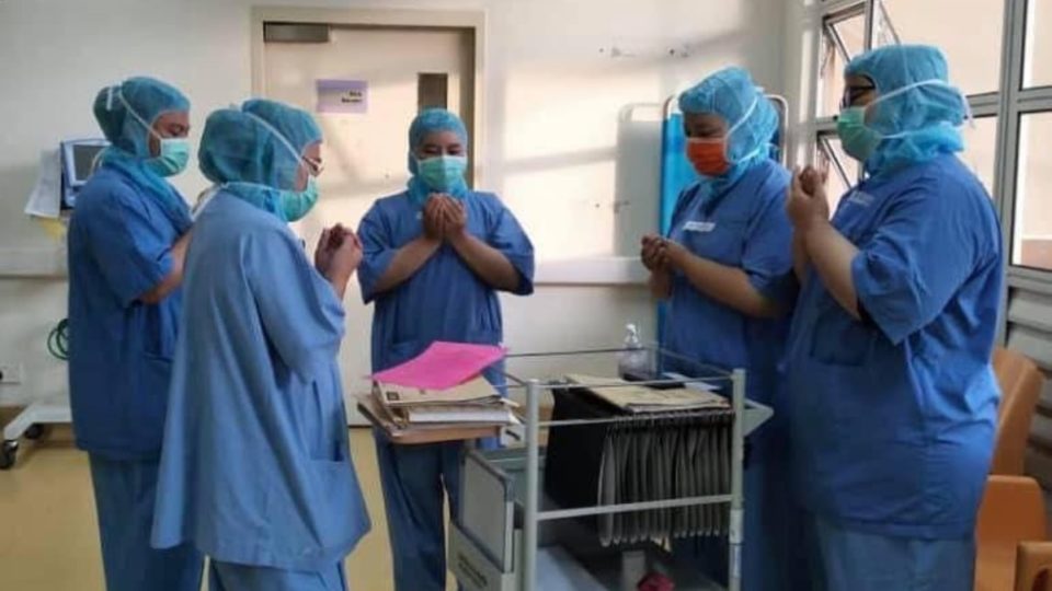 Health workers gathered around in prayer. Photo: Noor Hisham Abdullah
