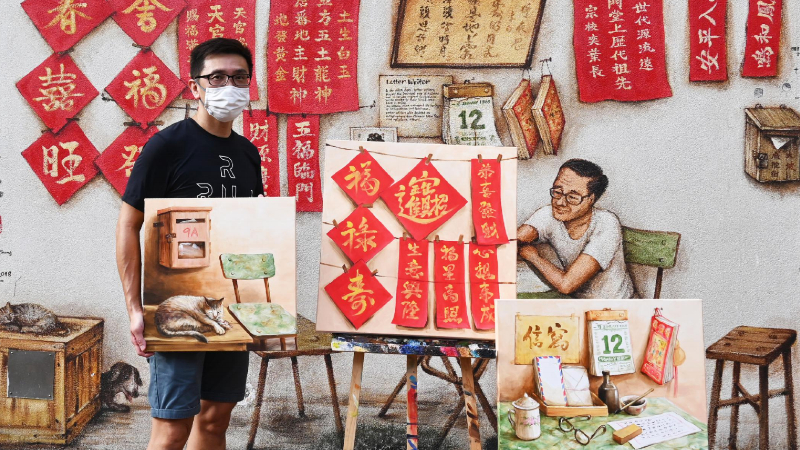 Yip Yew Chong poses in front of one of his most popular murals in Chinatown. Photo: Art Porters Gallery