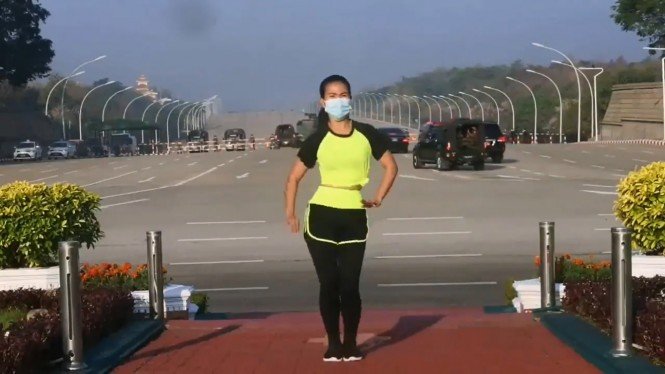 Myanmar woman recording an aerobics workout video while a convoy of military vehicles heads towards the parliament building amid a coup d’état. Photo: Video screengrab from Khing Hnin Wai