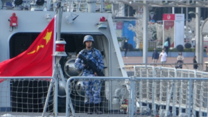 An armed soldier stationed at the deck of the Huizhou warship. Photo via Apple Daily
