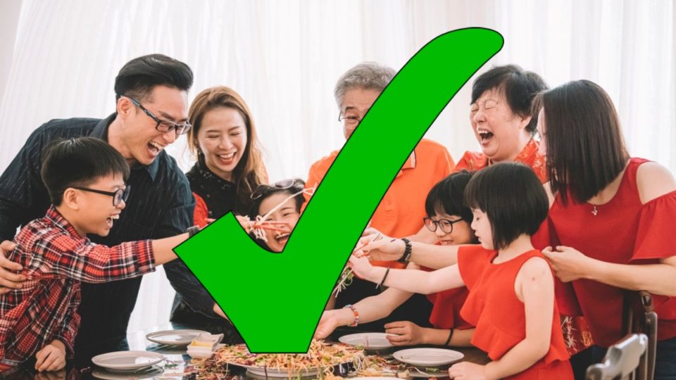 The ‘tick’ symbol over a photo of a family tossing salad. Photo: Coconuts
