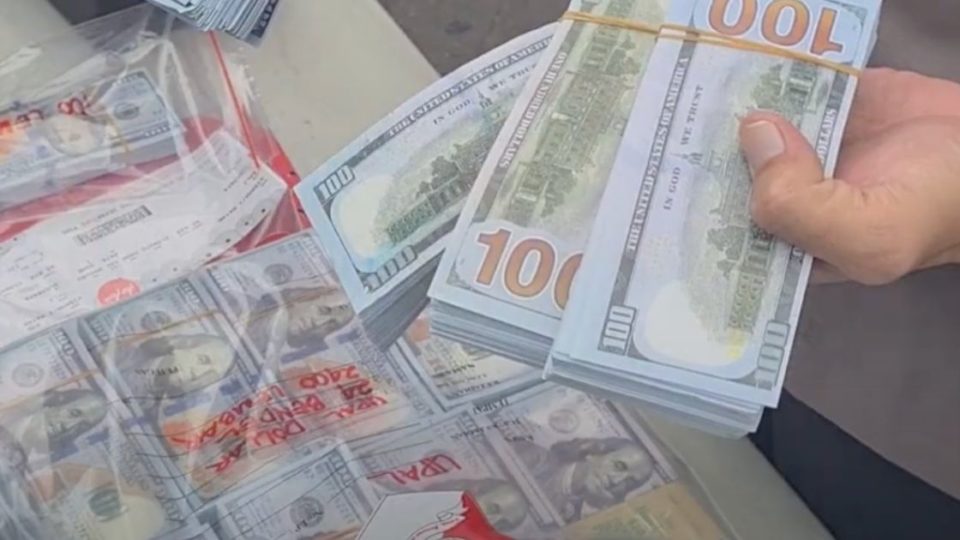 The suspects intended to deposit 15,000 one hundred US dollar bills. Screengrab: Youtube/Humas Polrestabes Surabaya