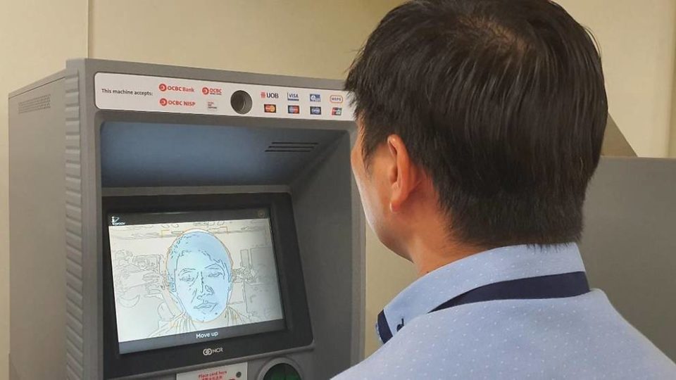 A man testing out the face recognition feature at an OCBC ATM. Photo: OCBC
