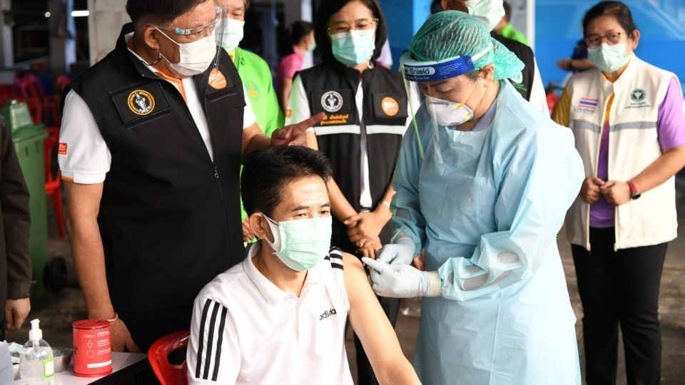 Officials pose for a photo op at a free inoculation site in Bangkok’s Bang Khae district, where cases flared last month. Photo: Bangkok Metropolitan Administration